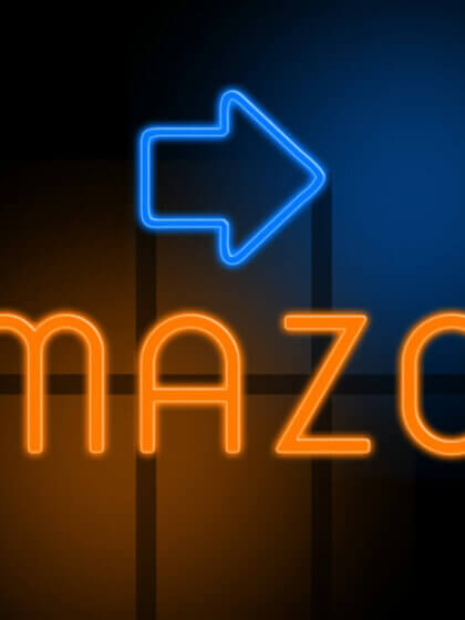 Amazon - orange glowing text with an arrow on dark background