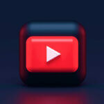 a red and black square with a play button / YouTube