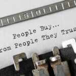 Kundenbindung / Text People Buy From People They Trust typed on retro typewriter