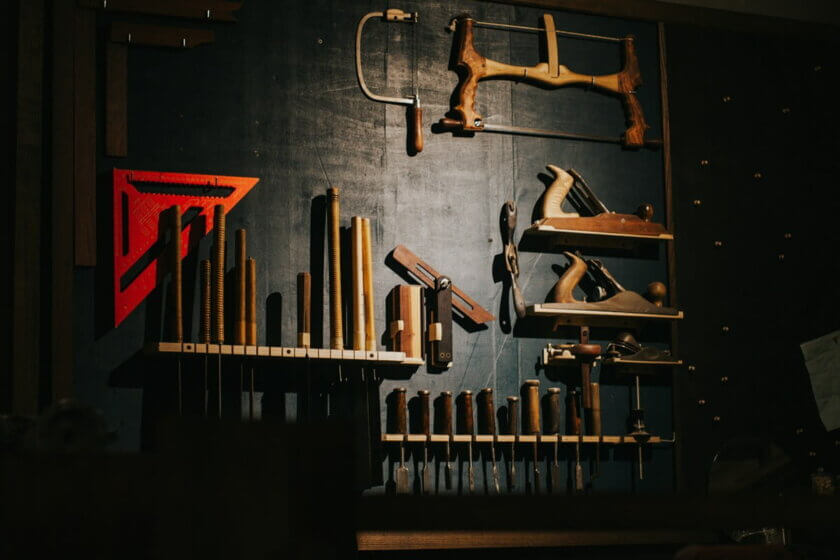 Organisierte Werkzeugwand mit verschiedenen Holzwerkzeugen – Symbolbild für die strukturierte Auswahl von KI-Tools im Arbeitsalltag
